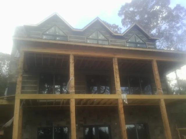 Dormers and porch framing on a large log home under construction in Buffalo